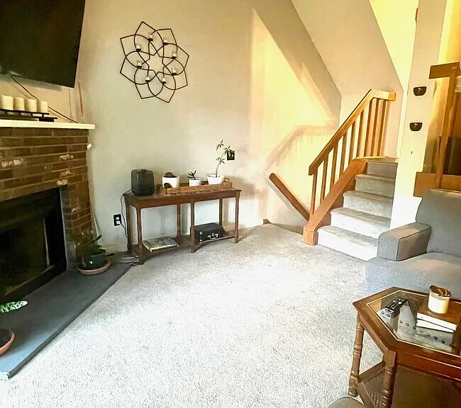 4th View: Sunken living room with fireplace and sliding glass doors leading to a private deck.