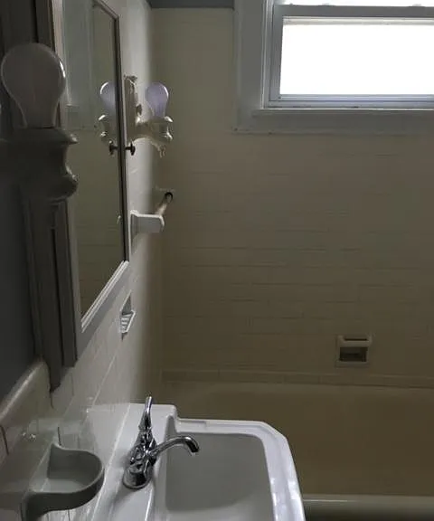 3/4 tiled bathroom with hand stenciled wallpaper