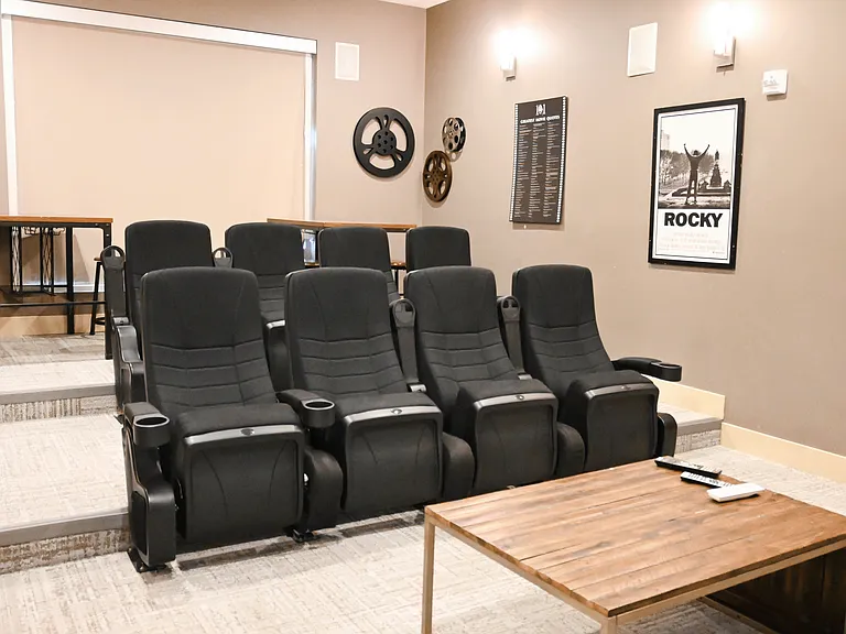 Two rows of chairs in the theater room at The Sterling.