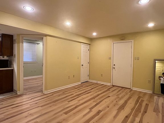 Living Room showing separate entrance on the right and bedroom door on the left