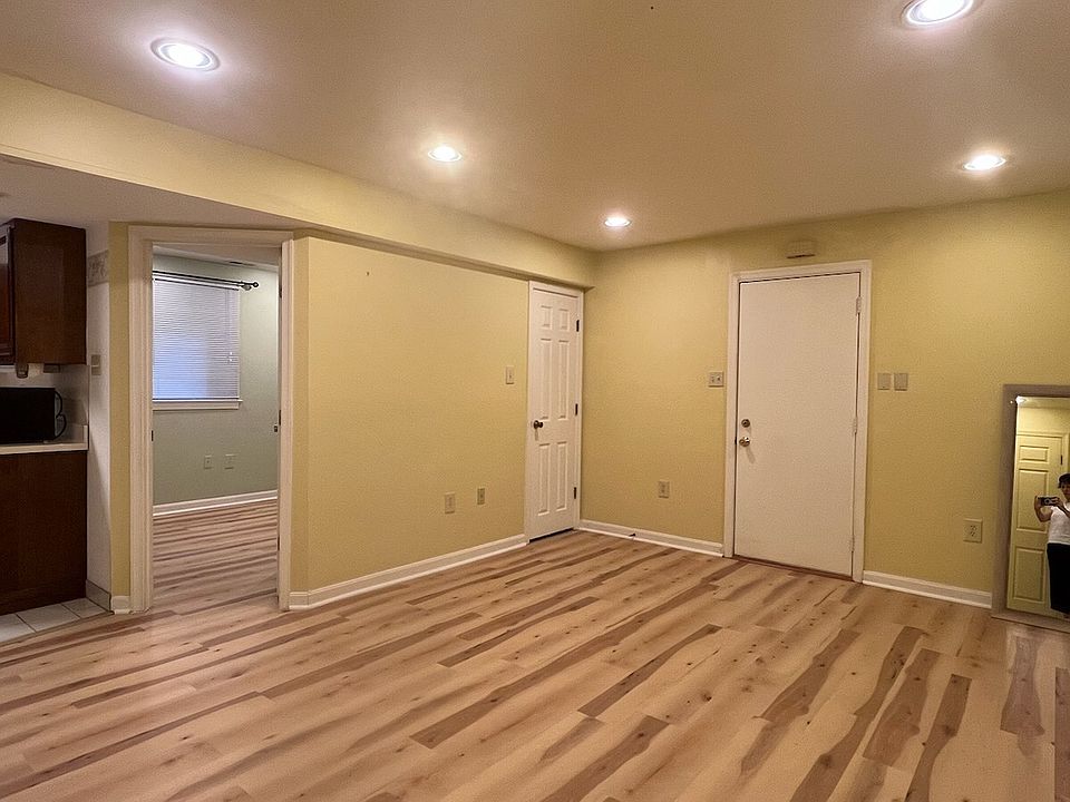 Living Room showing separate entrance on the right and bedroom door on the left