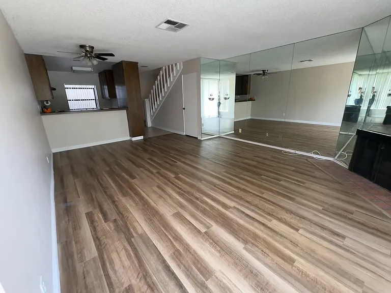 View standing at patio sliding door, kitchen counter has bar height counters