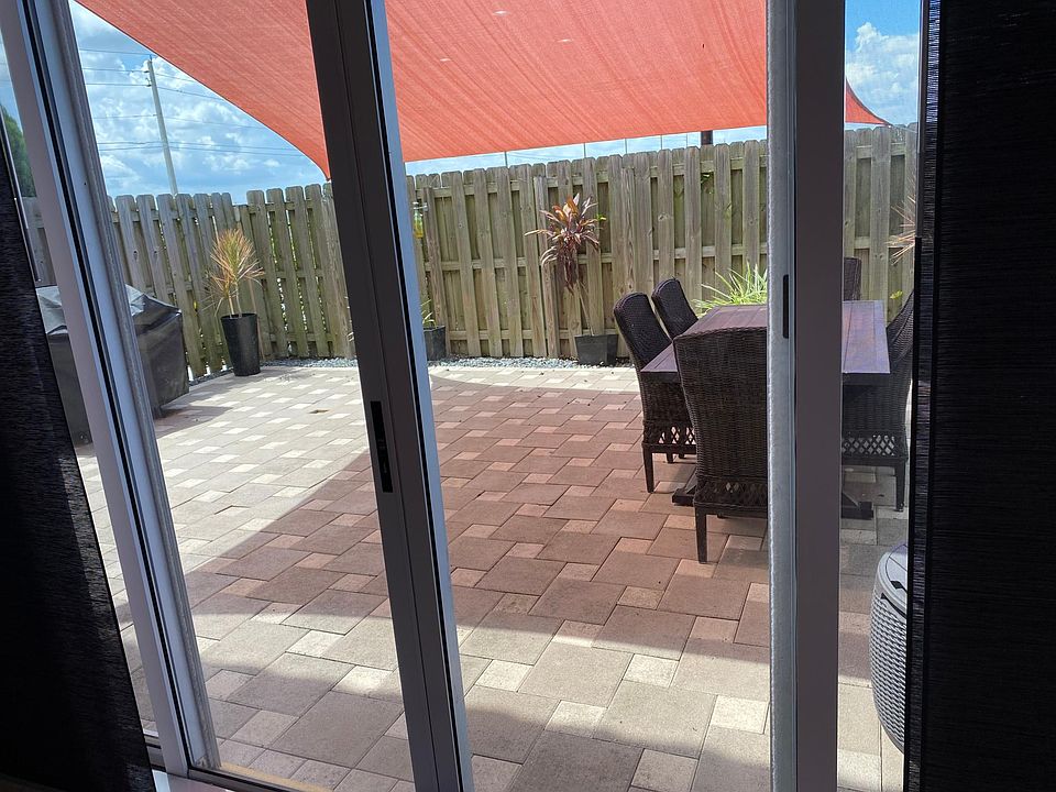 Paved patio with sail shade