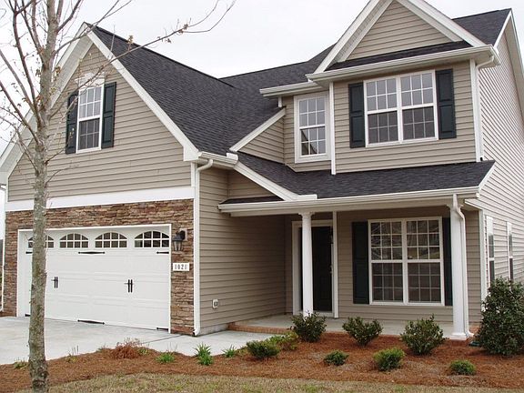 Handsome stone work and landscaped yard