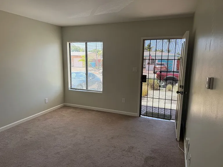 View of front door from living room/entrance hall