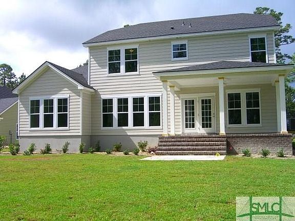 REAR VIEW WITH SPACIOUS COVERED PORCH