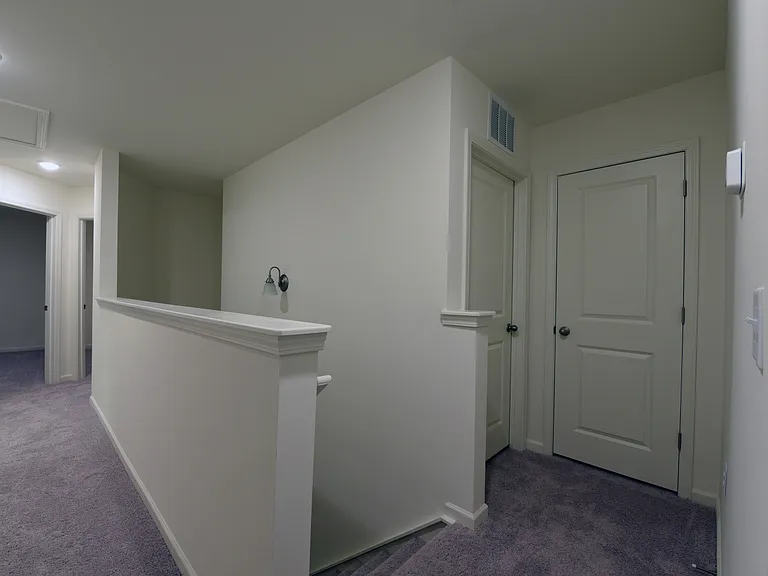 Upstairs view of linen closet and laundry room
