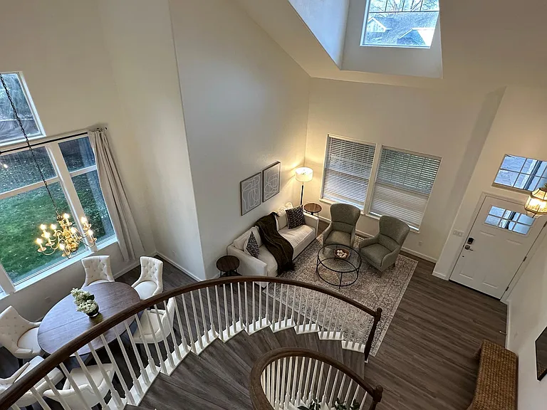 Vaulted ceiling, curving staircases, and large windows.