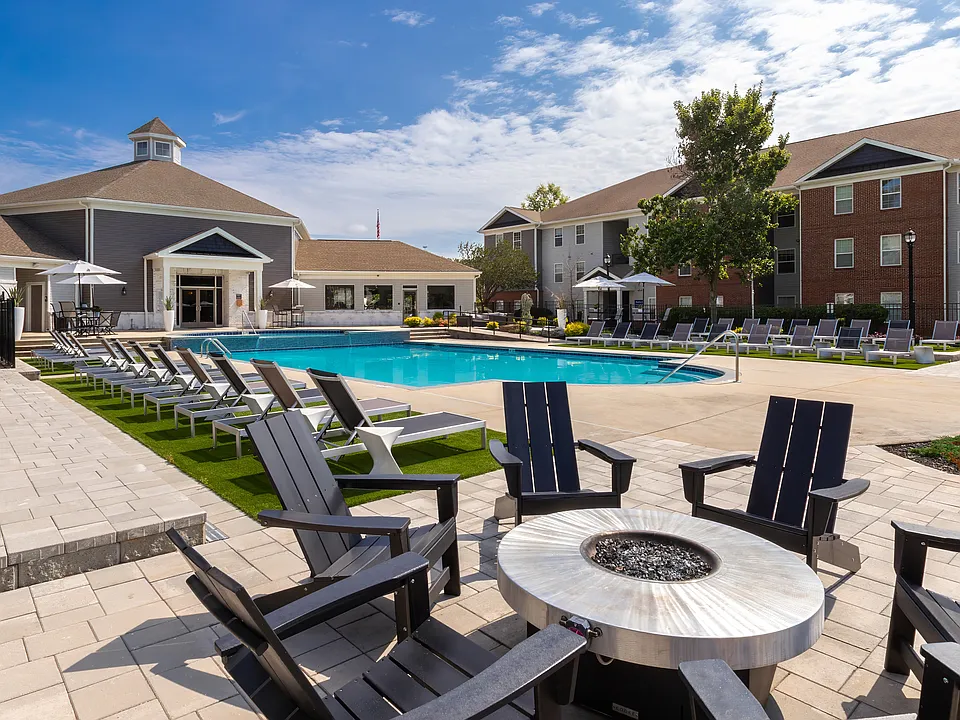 Relax poolside with comfortable chairs and table seating for entertaining and lounging, professionally operated by Highlands Vista Group.