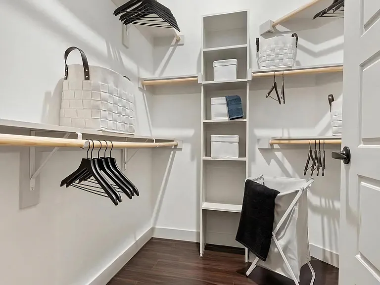 Walk-In Closet with Built-In Shelves, Hangers, and Laundry Basket