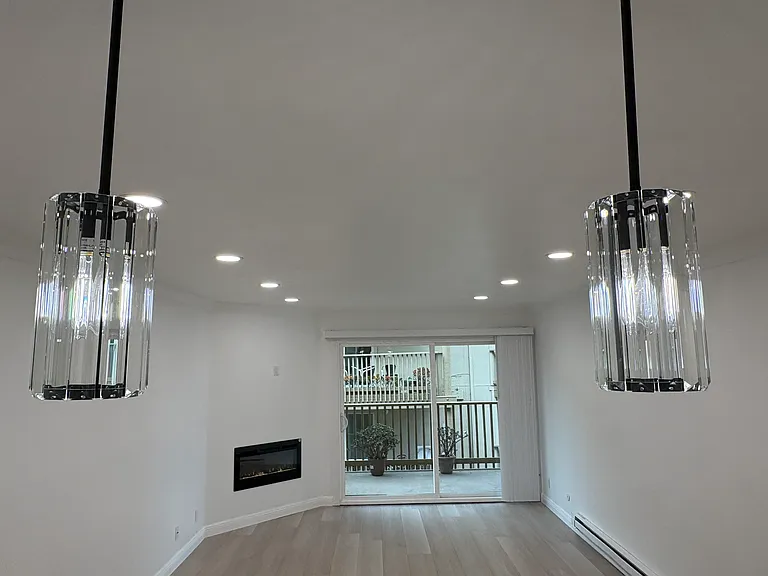 Two pendant lights add ambiance to the rest of the living room