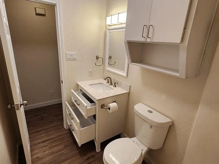 New LED lighting, dual-flush toilet, cabinet storage. And a vanity with drawers!