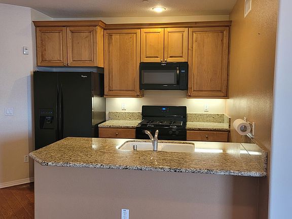 Kitchen with granite countertop and island.