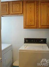 Main floor laundry with cabinets.