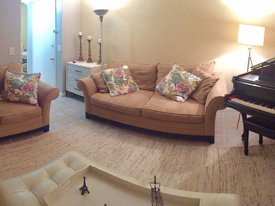 Living room leading to kitchen area on the right and hallway on the left