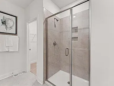 Beautifully tiled walk-in shower featuring a built-in bench and recessed niche for shower essentials.