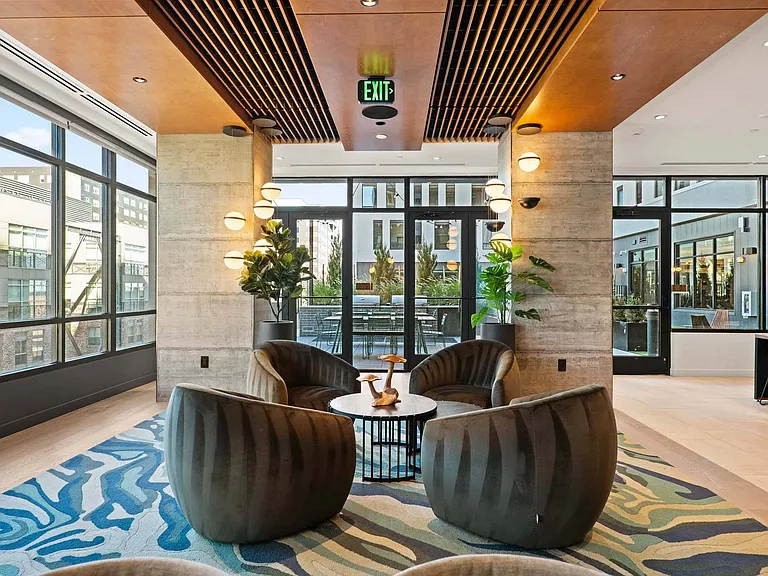 Admire the view in a lounge with floor-to-ceiling windows and cozy chairs perfect for relaxing.