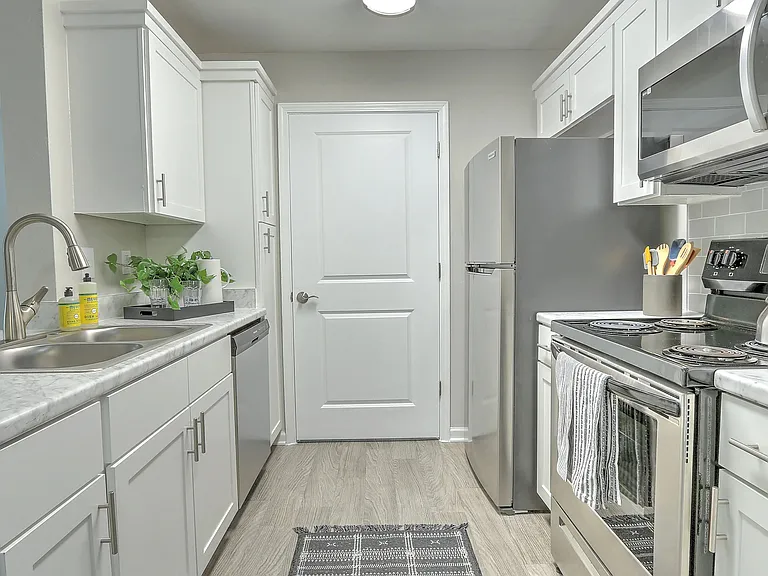 Discover designer kitchen elegance with ample storage in our updated kitchens.