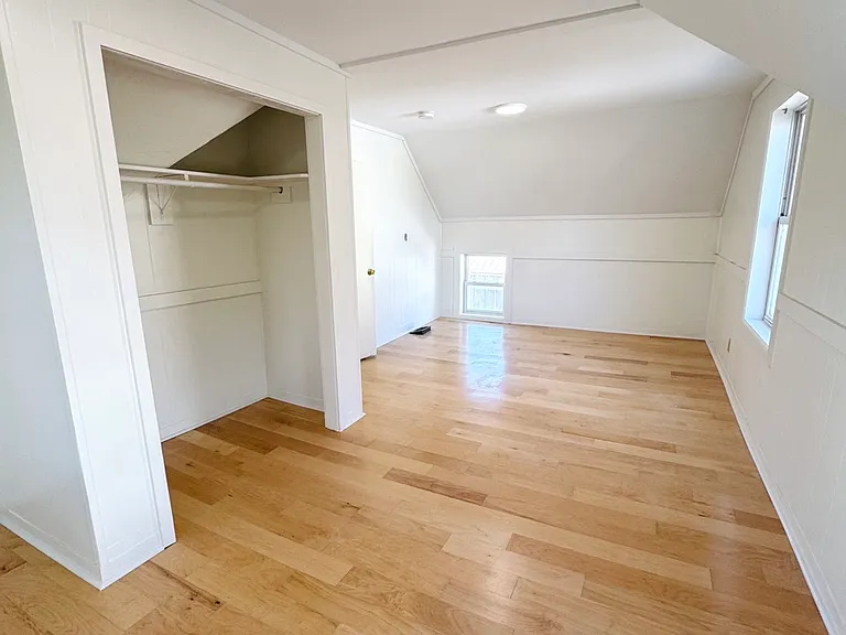 Bedroom 1: large bedroom with closet and four windows, upstairs