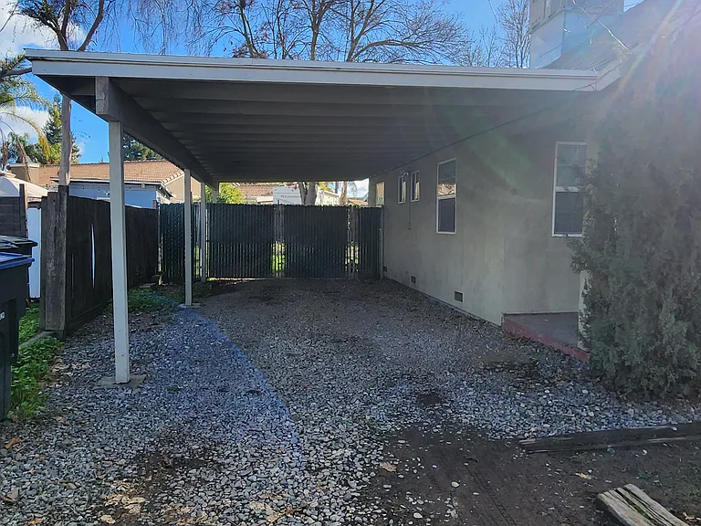 Attached carport on East side of house
