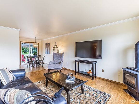 The family room gives a warm and inviting feel with its fresh paint and cozy gas stove, which effeciently heats the entire home keeping heat bills to a minimum in the wintertime.