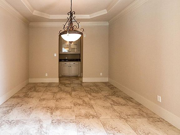 Formal Dining: Crown molding, tile floor, bar