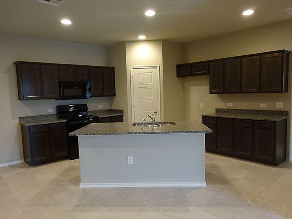 Kitchen with center island for barstools, new appliances: oven, microwave, dishwasher. There is a refrigerator included (not shown here)