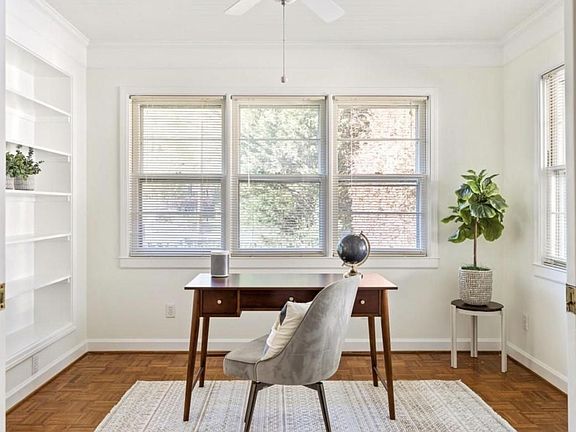 Office space with built in bookshelves or perfect room for nursery.