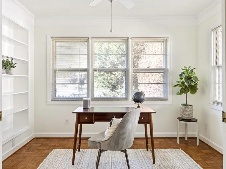 Office space with built in bookshelves or perfect room for nursery.