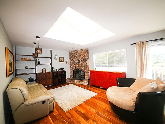 Living room with fireplace and oversized skylight