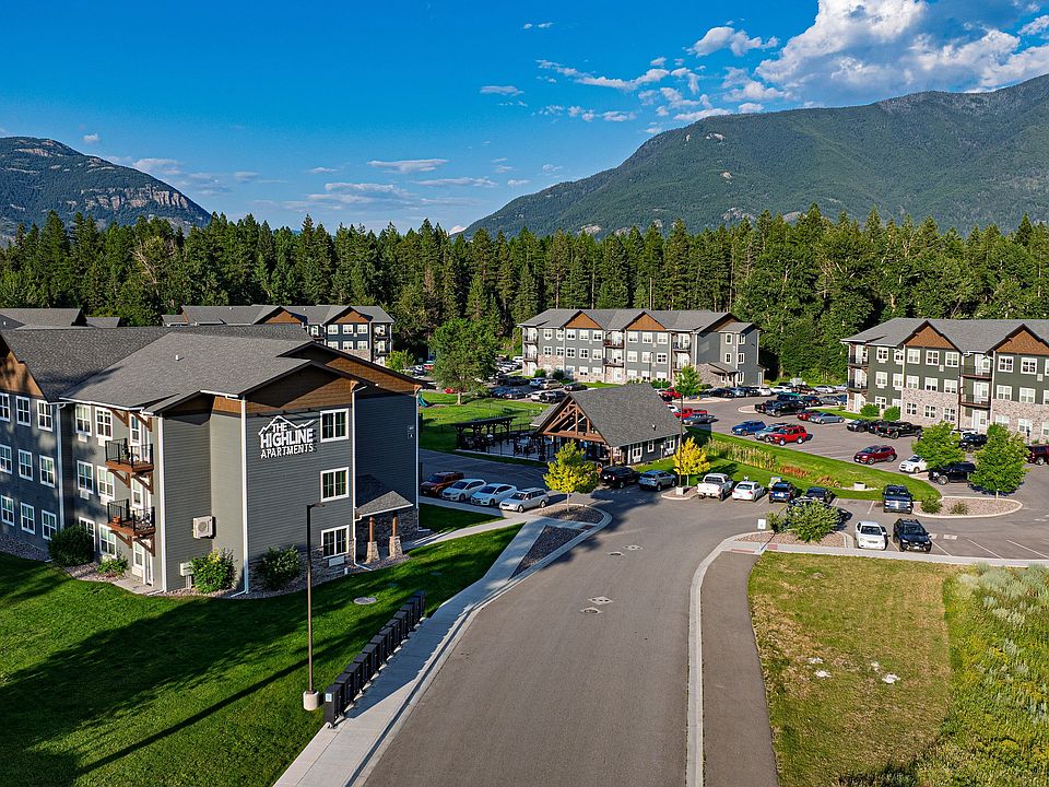 Charming apartment complex nestled amidst lush greenery with scenic mountain views