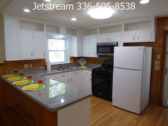 Kitchen with new gas stove, new microwave, and new frig