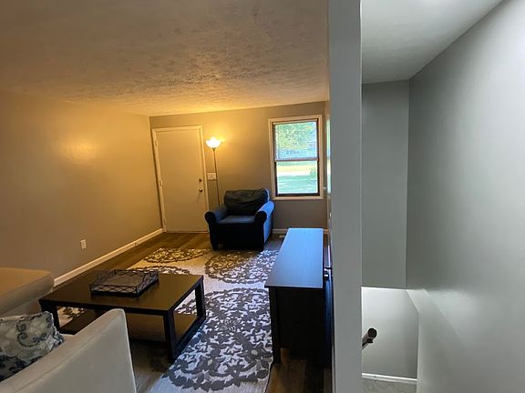 Upper level living/dining area. Stairs to lower level. Door leads to common entry area.