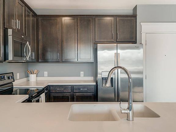 A modern kitchen with rich cabinetry and sleek finishes makes every meal feel like an experience.