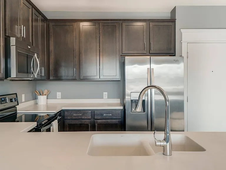 A modern kitchen with rich cabinetry and sleek finishes makes every meal feel like an experience.