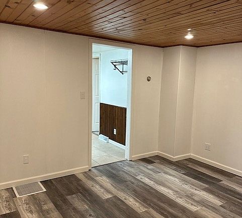 A View of Living Room with Entrance to Kitchen in Background.