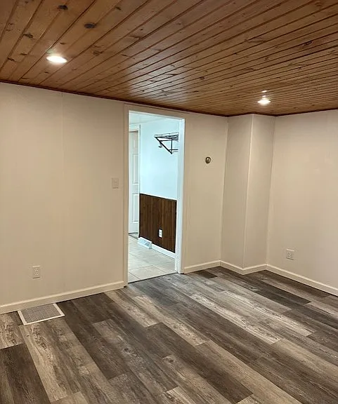 A View of Living Room with Entrance to Kitchen in Background.