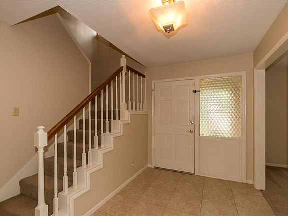 The foyer has an updated stylish light fixture and 18"x18" ceramic tile(as does the dining room, breakfast area and kitchen)