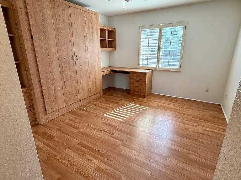 Bedroom 2 with built-in Murphy bed frame and desk with drawers