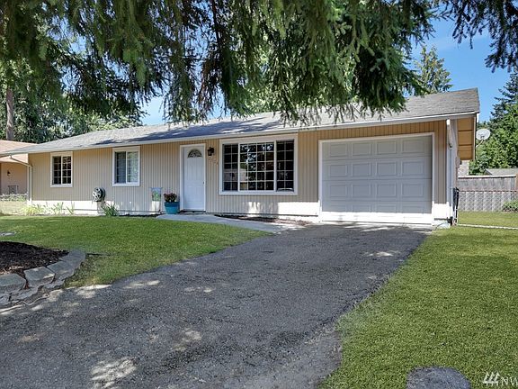 Attached garage, newer windows, and exterior light welcomes you home
