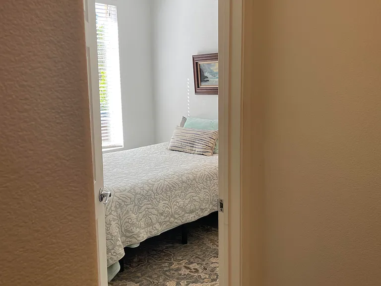 Entering the second bedroom directly across from the second bathroom.