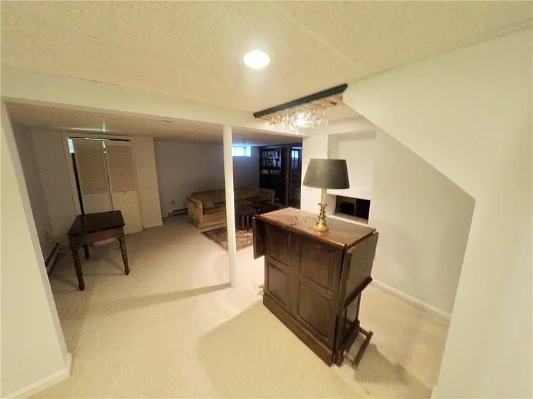 Basement pub. Carpeted, unfurnished.