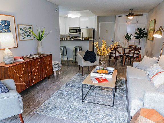 Spacious living room view of fully renovated kitchen