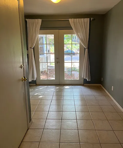Bonus space in front of the french doors. Works for breakfast nook table or additional work space looking towards outside.