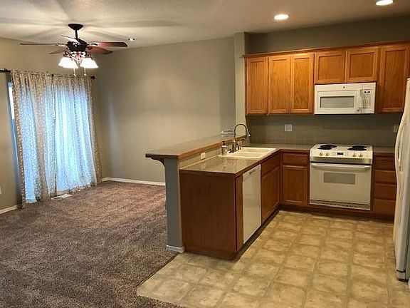 Dining area, eat bar, dishwasher, double sink, microwave, stove/oven & refrigerator included. Pantry in kitchen.