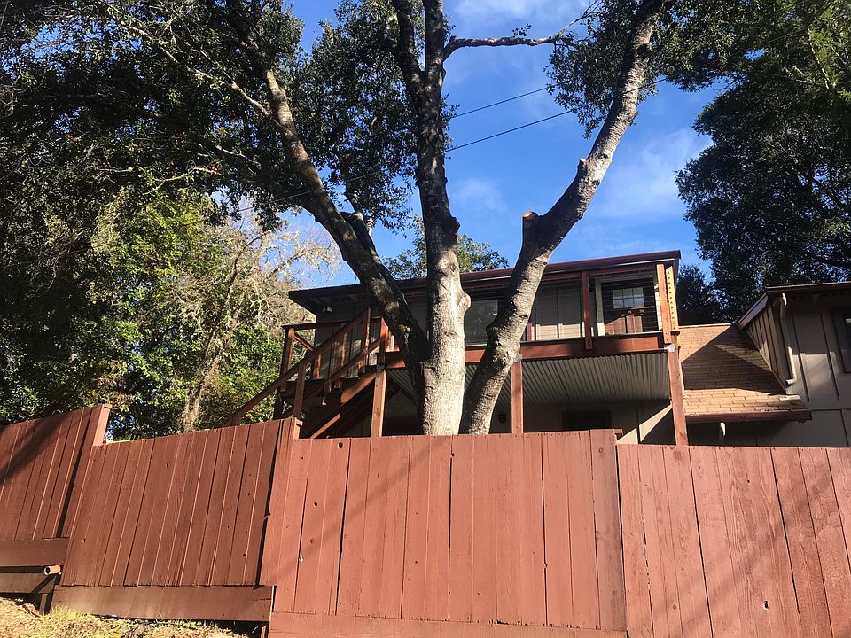 Front view of home with enclosed fenced garden upstairs deck with sunny mountain views of Castle Rock State Park.