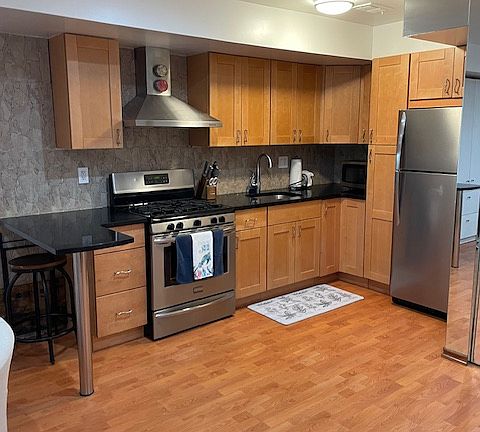 Kitchen area with ample storage and breakfast bar.