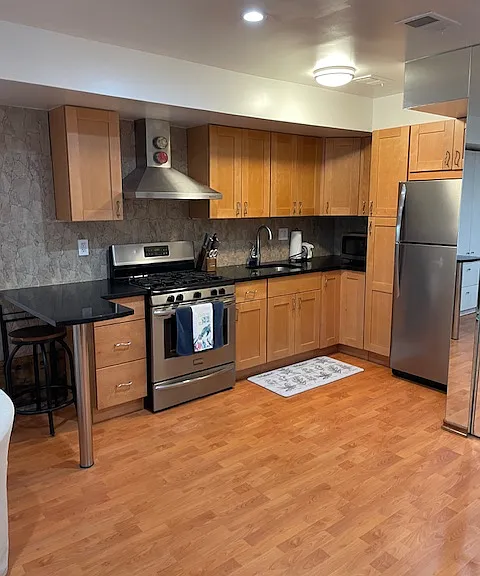 Kitchen area with ample storage and breakfast bar.