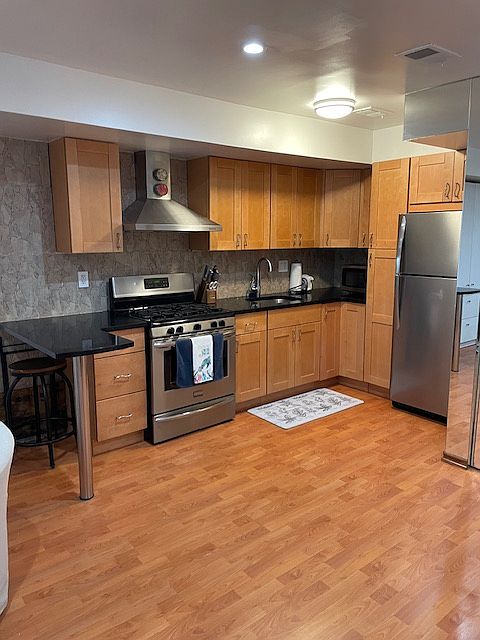 Kitchen area with ample storage and breakfast bar.