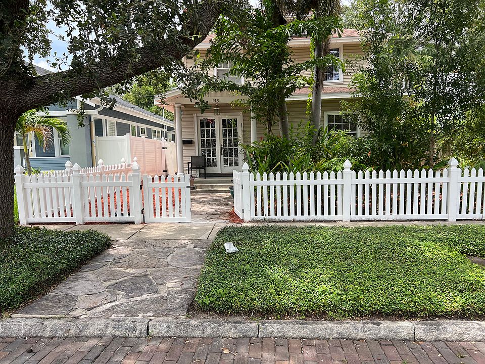 Front of House with new white fence